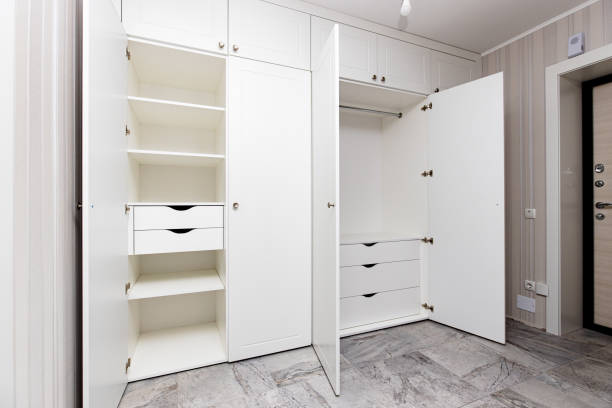 Effortlessly Organized Reach-In Closet by Amaya Modern reach-in closet with custom shelving, organized clothing, and stylish finishes by Amaya.